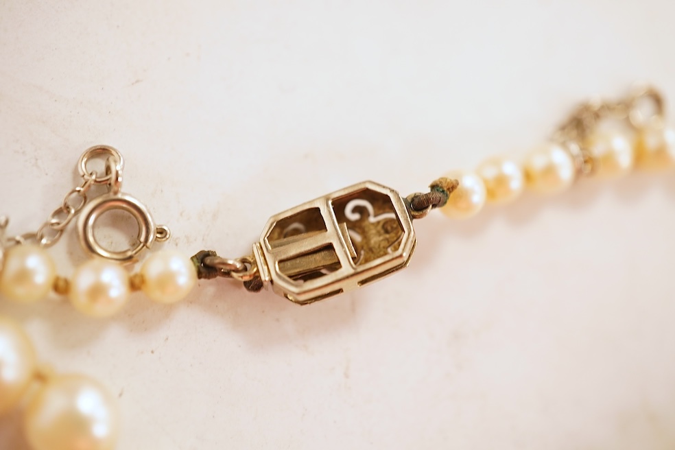 A cultured pearl and diamond necklace, early 20th century, composed of a single strand of graduated natural pearls measuring approximately 3.5-7.9cm, to a clasp set with a circular-cut diamond weighing approximately 0.07